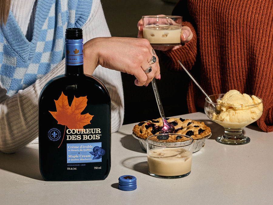 a couple drinking coureur des bois whiskey liquor with desserts