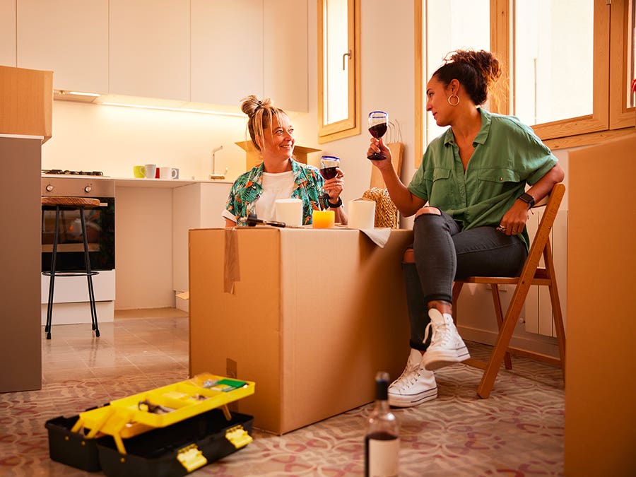 A couple enjoying a glass of wine after moving.