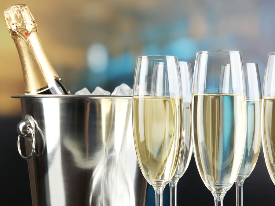 Champagne bottle in an ice bucket, with flutes.