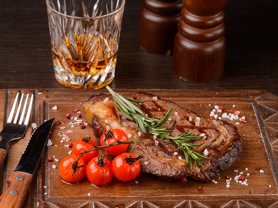 Glass of rum with steak