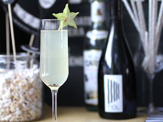 Glam cocktail with a slice of star fruit Glam cocktail with a slice of star fruit
